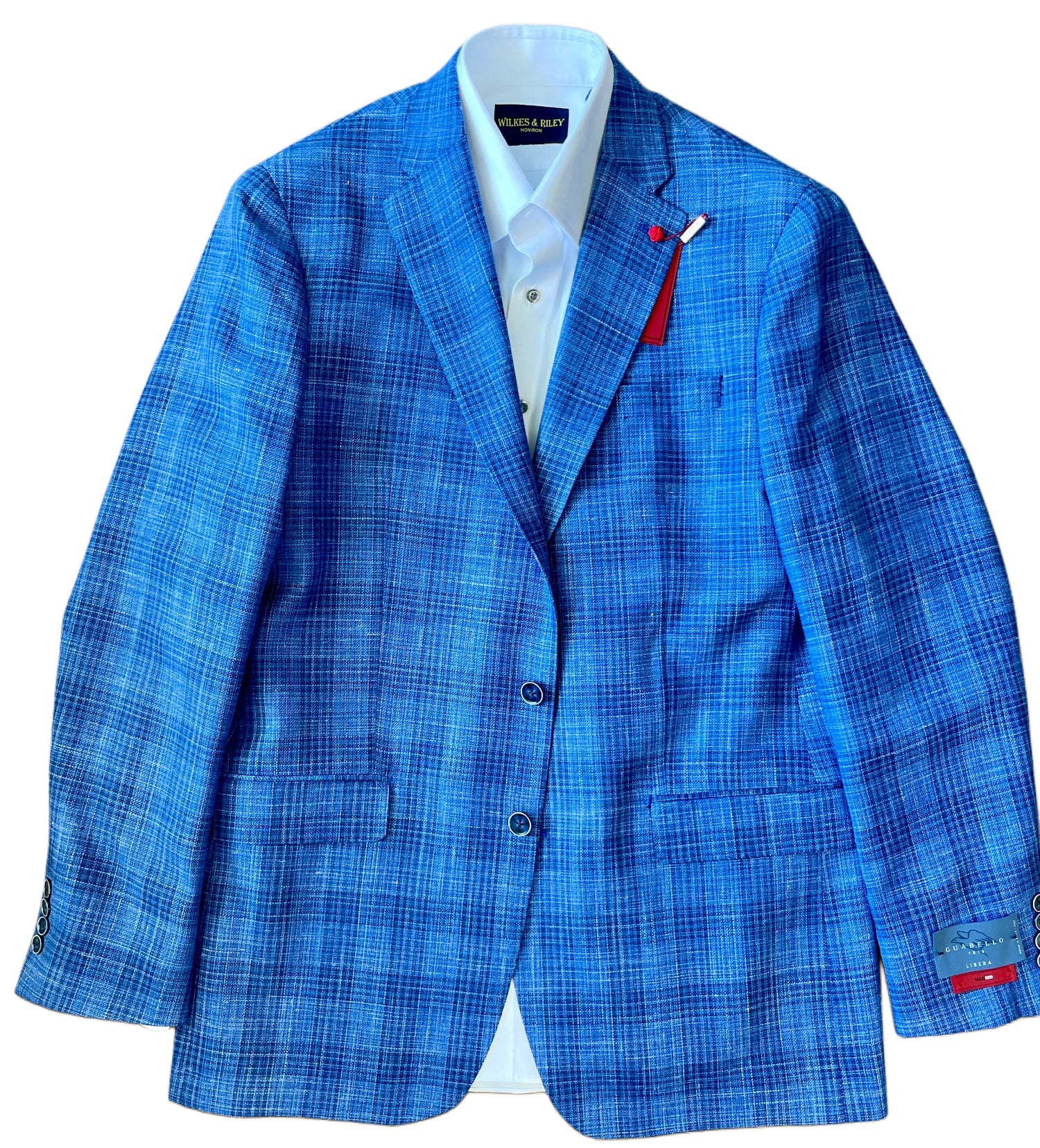 The TailoRed Gianni Sport Coat 8130534 is a blue plaid blazer made from premium Italian fabric, featuring two buttons, notch lapels, and flap pockets, shown styled over a white dress shirt on a plain background.