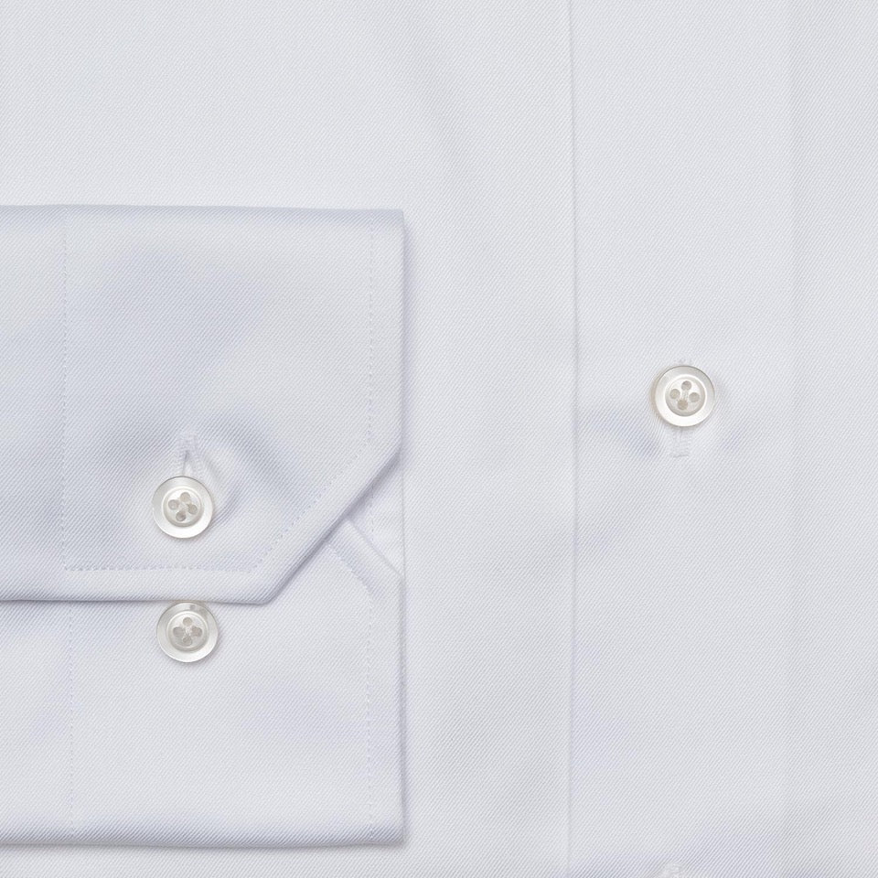 Close-up of the Hagen Twill Dress Shirt MB1862100 by Hagen, crafted from premium cotton twill, featuring a view of the sleeve with two buttons and part of the front with two additional buttons—an essential addition to any formal wardrobe.