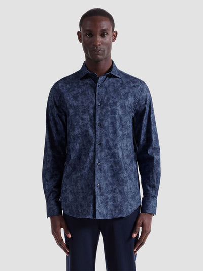 A man faces forward against a light background wearing the Bugatchi Axel Woven Sport Shirt HS3050L40S, a long-sleeve, button-up dark blue patterned shirt by Bugatchi.