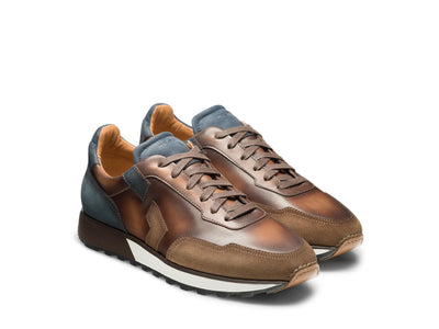 The Magnanni Aero sneakers by Magnanni feature retro runner styling in brown and blue, leather toes, white soles, brown laces, and a textured rubber outsole, shown side by side.