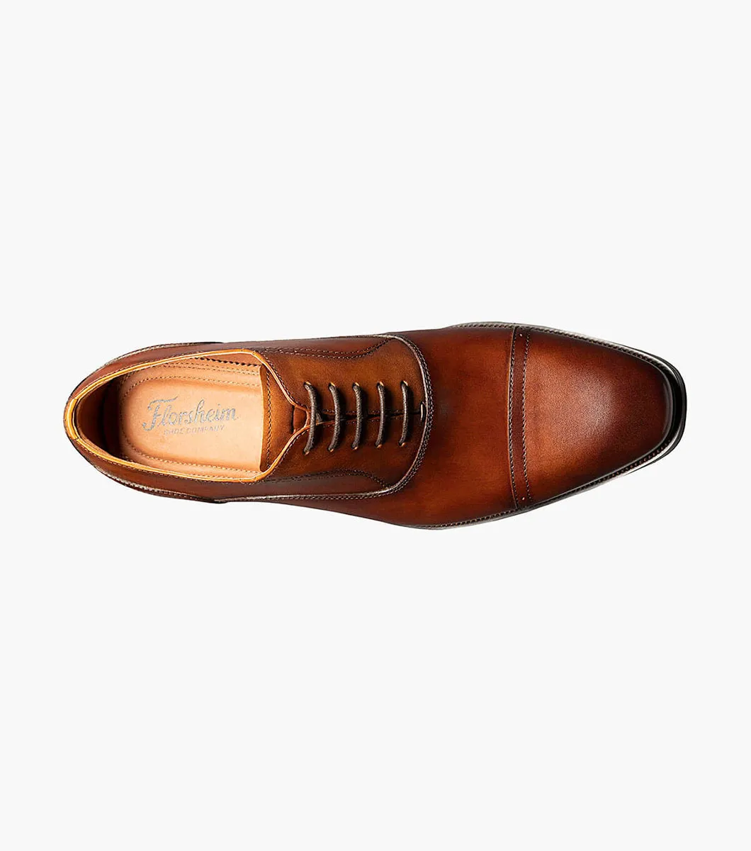 Top view of the Florsheim Sorrento Cap Toe Oxford, a brown leather dress shoe with laces, featuring a square toe, visible Florsheim branding on the insole, and a cushioned footbed for enhanced comfort.