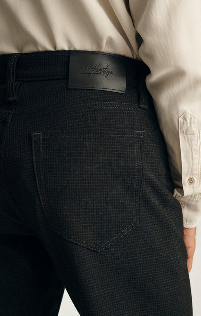 Close-up of a person wearing the 34 Heritage Courage Supreme Plaid pants and a light beige shirt.