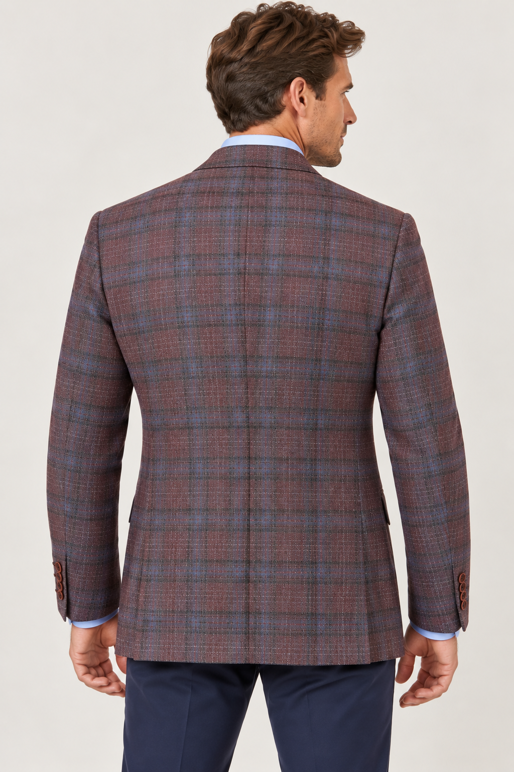Back view of a man wearing a maroon and blue Hart Schaffner Marx New York Burgundy Plaid Sport Coat 35H0128 over a light blue shirt.