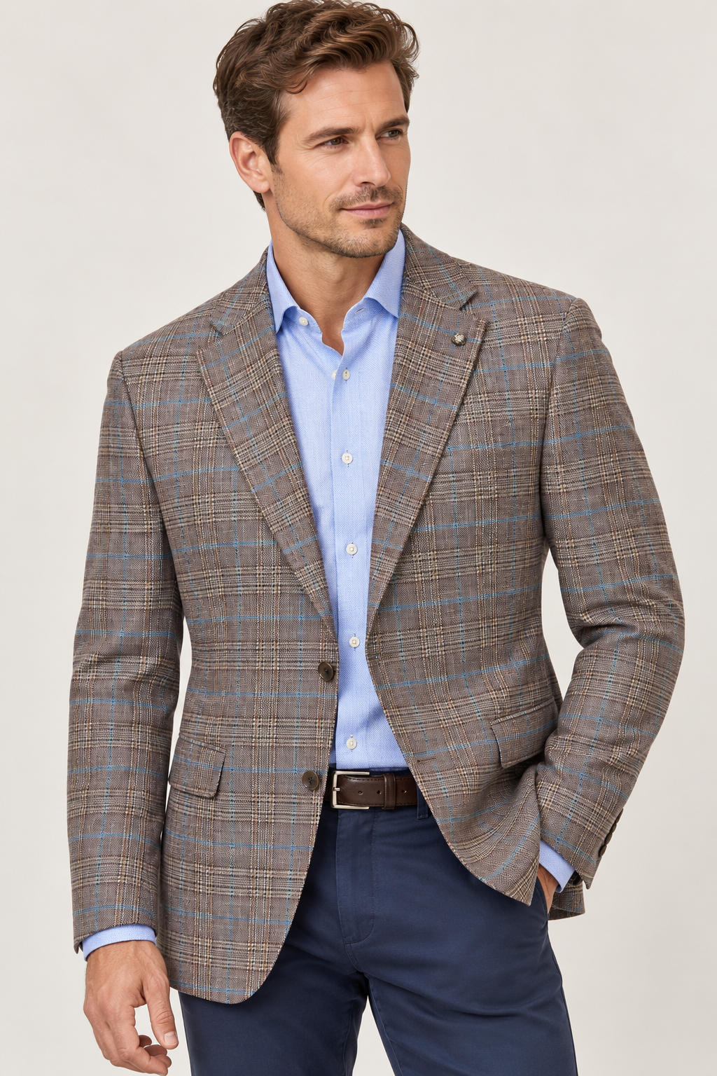 A man wearing a Jack Victor Conway Brown Plaid Sport Coat 1262312 over a light blue button-down shirt and navy trousers.