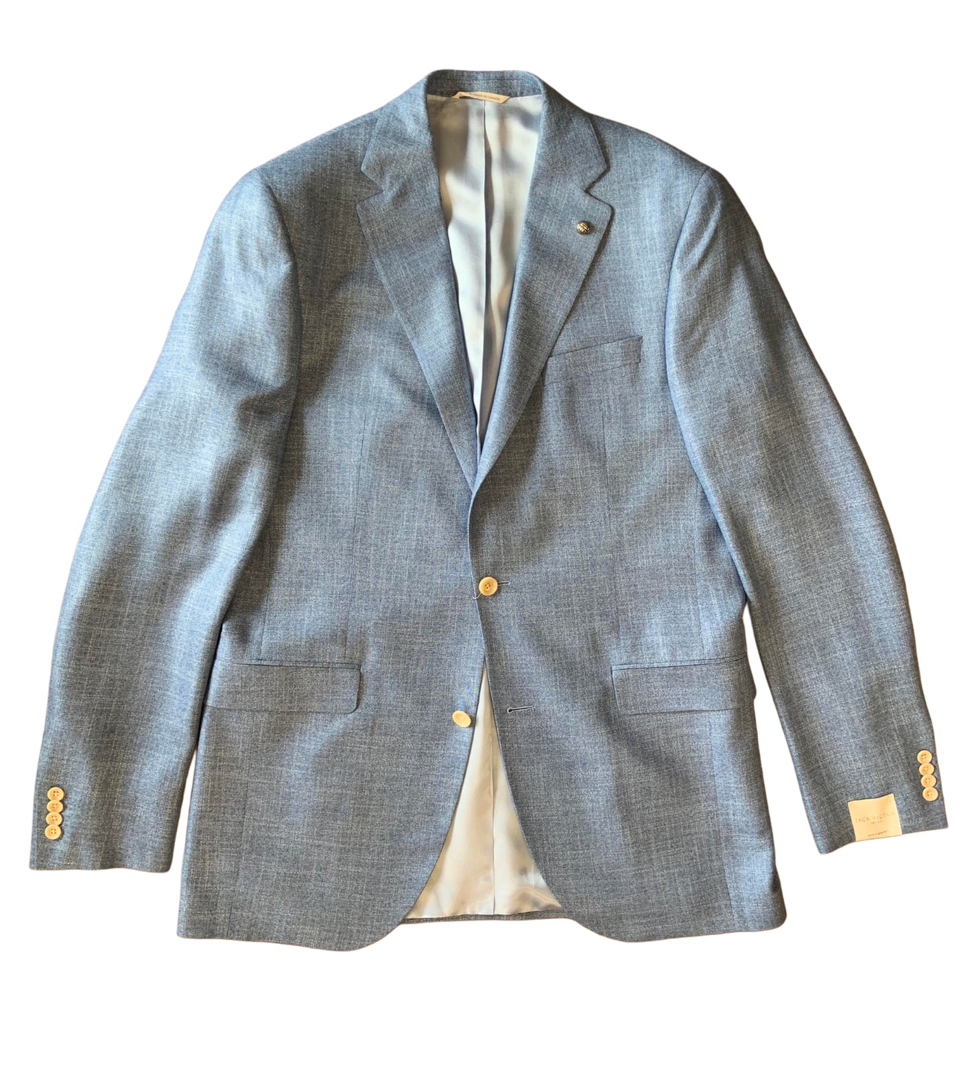 The Jack Victor Sport Coat Conway 1251301 is a light blue men’s blazer with notched lapels, two front buttons, three front pockets, and gold cuff buttons by Jack Victor, shown flat on a white background.