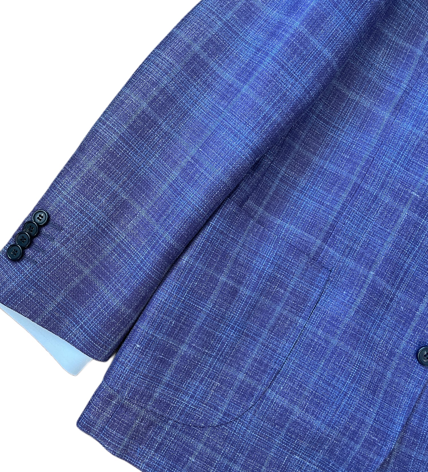 Close-up of the Byron Luca Soft Sport Coat 9547 sleeve in blue plaid, featuring three black buttons and two front pockets, displayed on a white background. Brand: Byron.