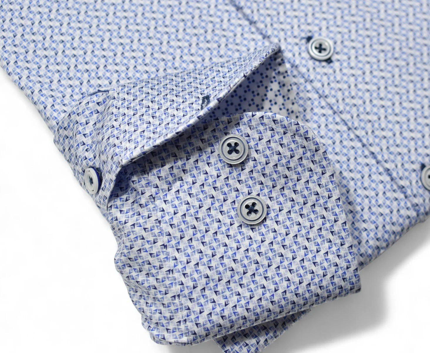 Close-up of a blue patterned shirt with buttons on a white background