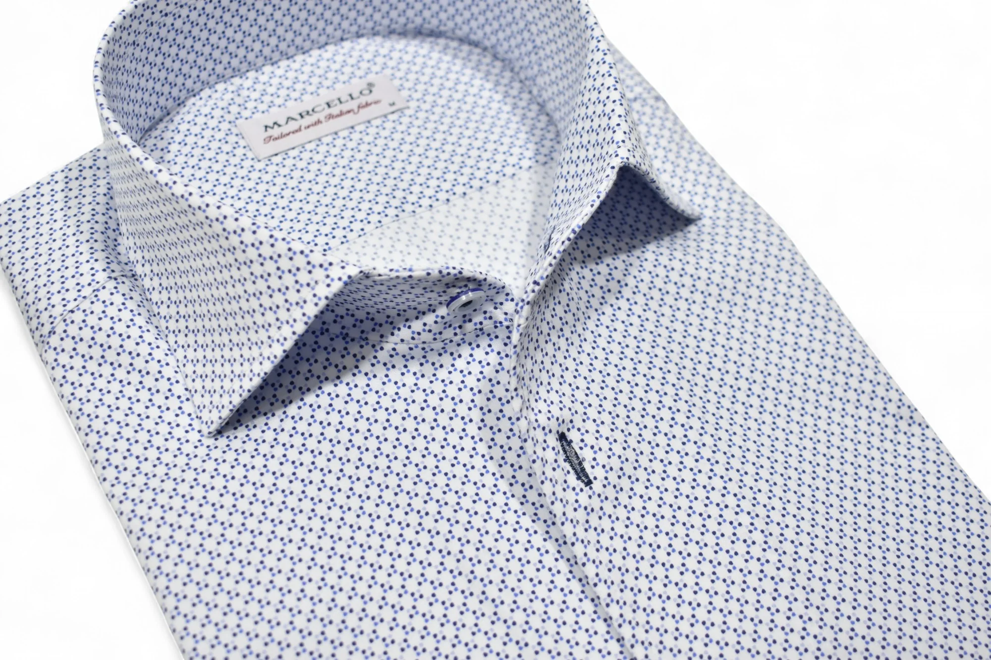 Close-up of a patterned shirt with a visible brand label on a white background