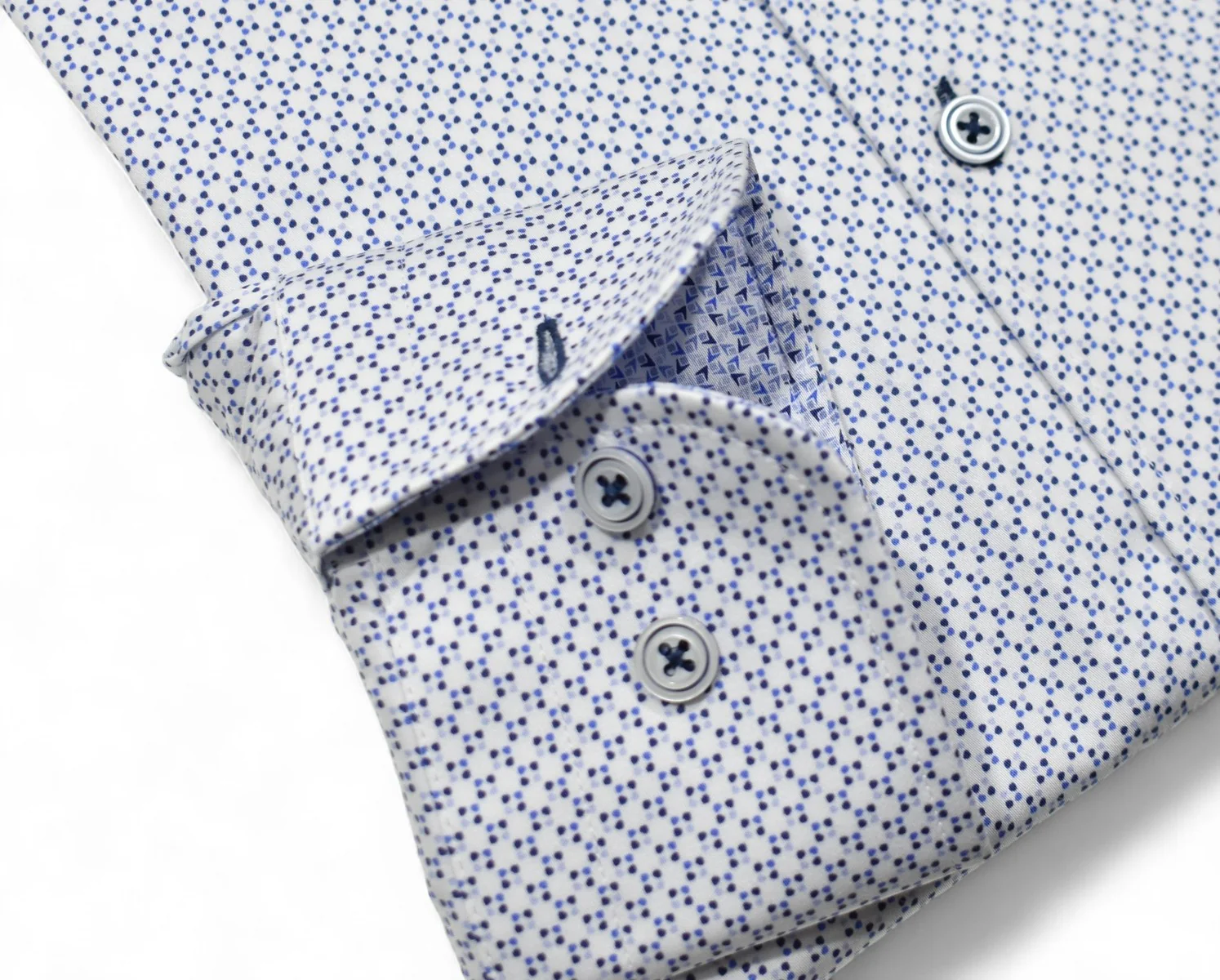 Close-up of a folded shirt with a subtle pattern on a white background