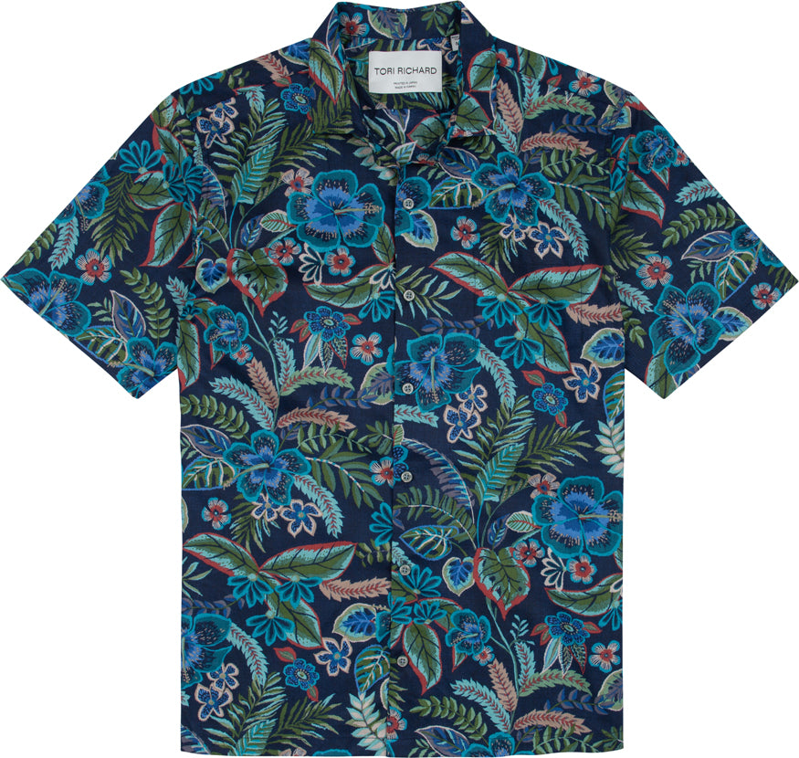 The Tori Richard Printed Cotton Flourish Shirt 1956M0329 is a short-sleeve button-up featuring a blue, green, and red tropical floral pattern on a dark background.