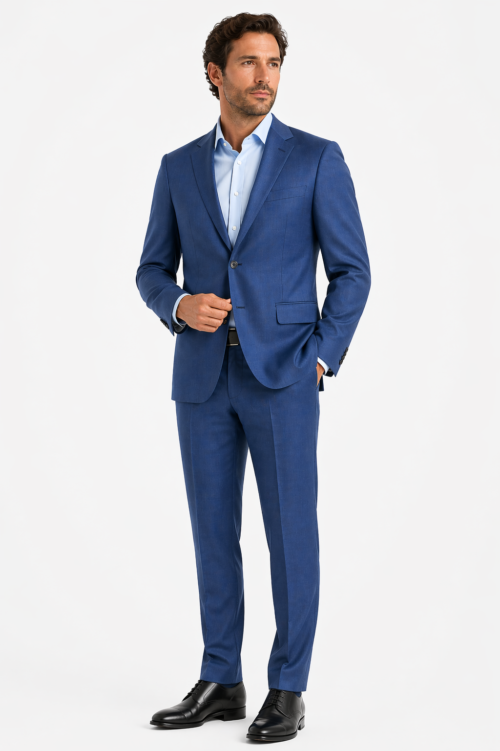 A man wearing the Byron Contemporary Luxe Suit 3708 by Byron in Italian wool, paired with a light blue dress shirt and black dress shoes, stands against a plain white background.