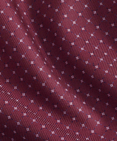 Close-up of maroon Pima cotton fabric from the David Donahue Micro Dot Sport Shirt CBSM11016, featuring a repeating grid of small white diamond-shaped dots.