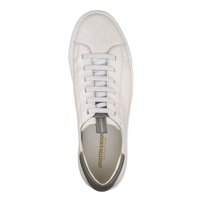 The Johnston & Murphy Anson is a white full grain leather sneaker with white laces, seen from above. The insole displays the Johnston Murphy logo in gold, and it has a cushioned EVA outsole for comfort.