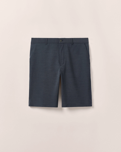 The Johnnie-O Mulligan Big & Tall Short by Johnnie-O is a dark blue, tailored golf short with four-way stretch, belt loops, side pockets, and a front button closure, shown against a plain light background.