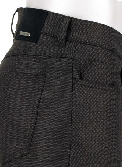 Close-up of the back and side pocket area of the dark gray textured Alberto Pipe Melange Birdseye Pant 1638, highlighting a belt loop, intricate stitching details, and a small metal Alberto brand tag near the waistband—these pants deliver a refined interpretation of classic regular fit trousers.
