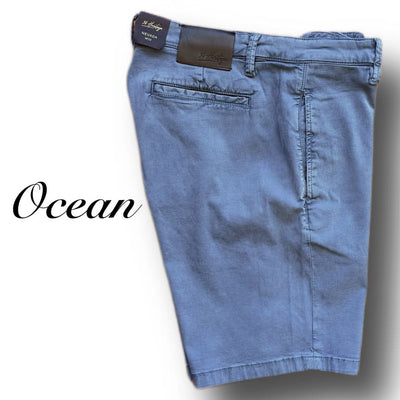 34 Heritage Nevada Soft Touch Shorts in light blue, men's slim fit, neatly folded with a brown leather waistband patch and "Ocean" in cursive. Made from Soft Touch fabric for superior comfort by 34 Heritage.