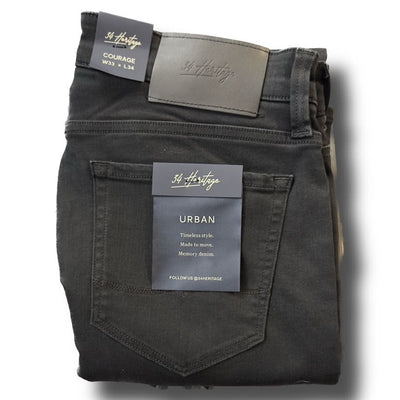 A folded pair of 34 Heritage Courage Black Urban Jeans, tagged W33 L34, showcases premium denim and timeless style in a straight leg fit.