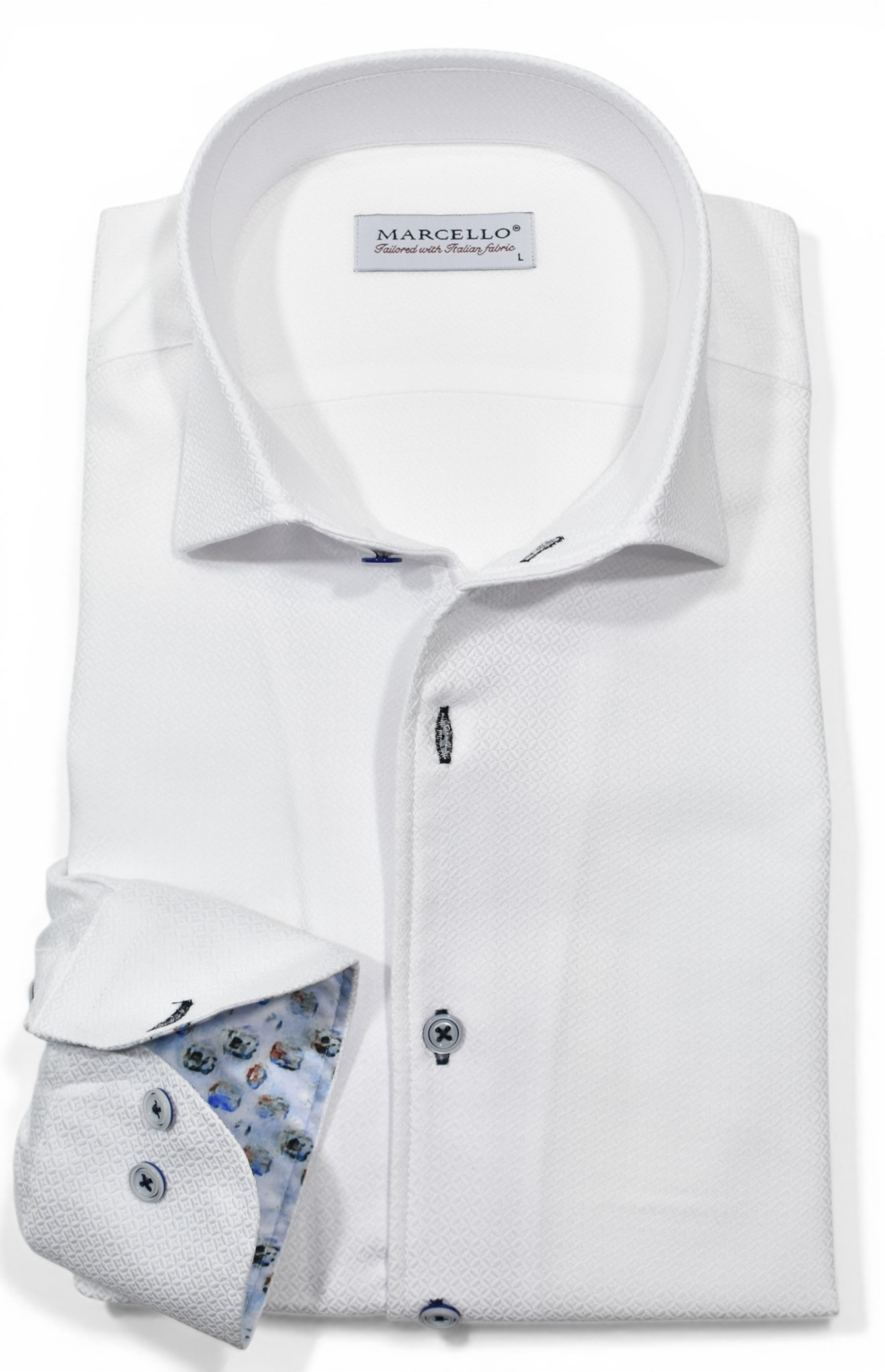 The Marcello Manhattan Diamond Sport Shirt DS125 is a classic fit white cotton shirt featuring a textured pattern, contrasting floral inner cuffs, blue buttons, and a branded one-piece collar.
