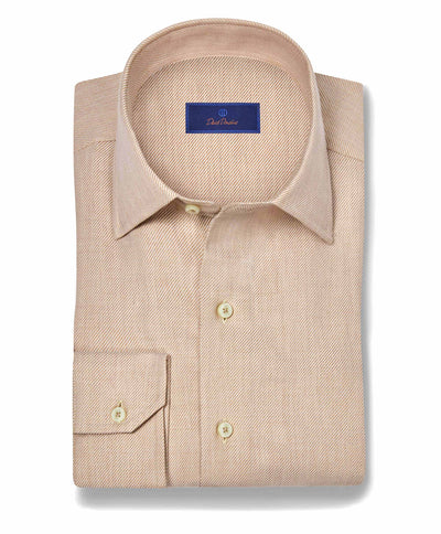 The David Donahue Cashmere Blend Shirt CBSM11101 is a folded light brown men’s sport shirt with a pointed collar, buttoned cuffs, and a blue label inside the collar.