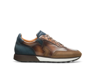 The Magnanni Aero by Magnanni is a sporty sneaker in brown and blue leather with a leather toe, white and black sole, and suede plus smooth panels, shown from the side.