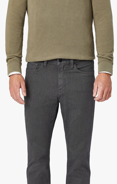 A person wears the 34 Heritage Charisma Diagonal Big&Tall trousers from 34 Heritage with a textured olive-green long-sleeve shirt, shown from shoulders to upper thighs, standing against a plain background.