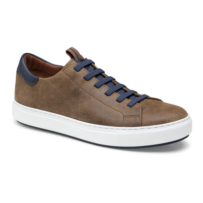 The Johnston & Murphy Anson is a brown low-top sneaker with navy blue laces and heel accent, cushioned EVA outsole, and white sole, displayed on a plain white background.