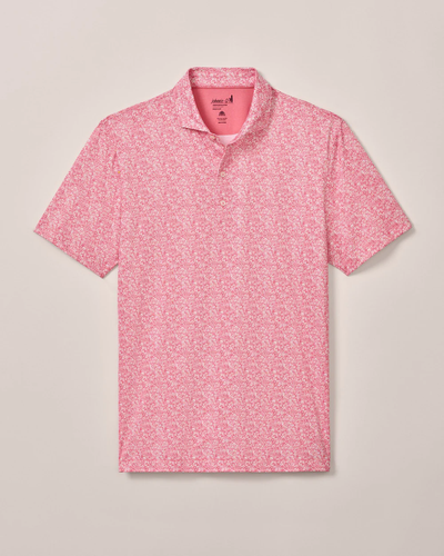 The Johnnie-O Performance Polo- Wildflower by Johnnie-O is a lightweight, short-sleeve polo featuring a pink and white floral pattern, shown flat on a neutral background.