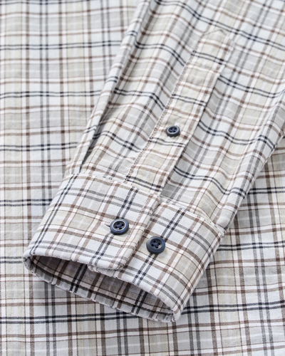 Close-up of the Johnnie-O Tahoe Plaid Flannel Shirt Big & Tall, a men’s shirt by Johnnie-O featuring a beige, brown, and black plaid pattern with a detailed view of the cuff and two black buttons.