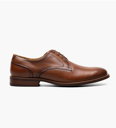 The Florsheim Rucci Plain Toe Oxford, a men's brown leather dress shoe with laces by Florsheim, is shown in side profile on a white background.