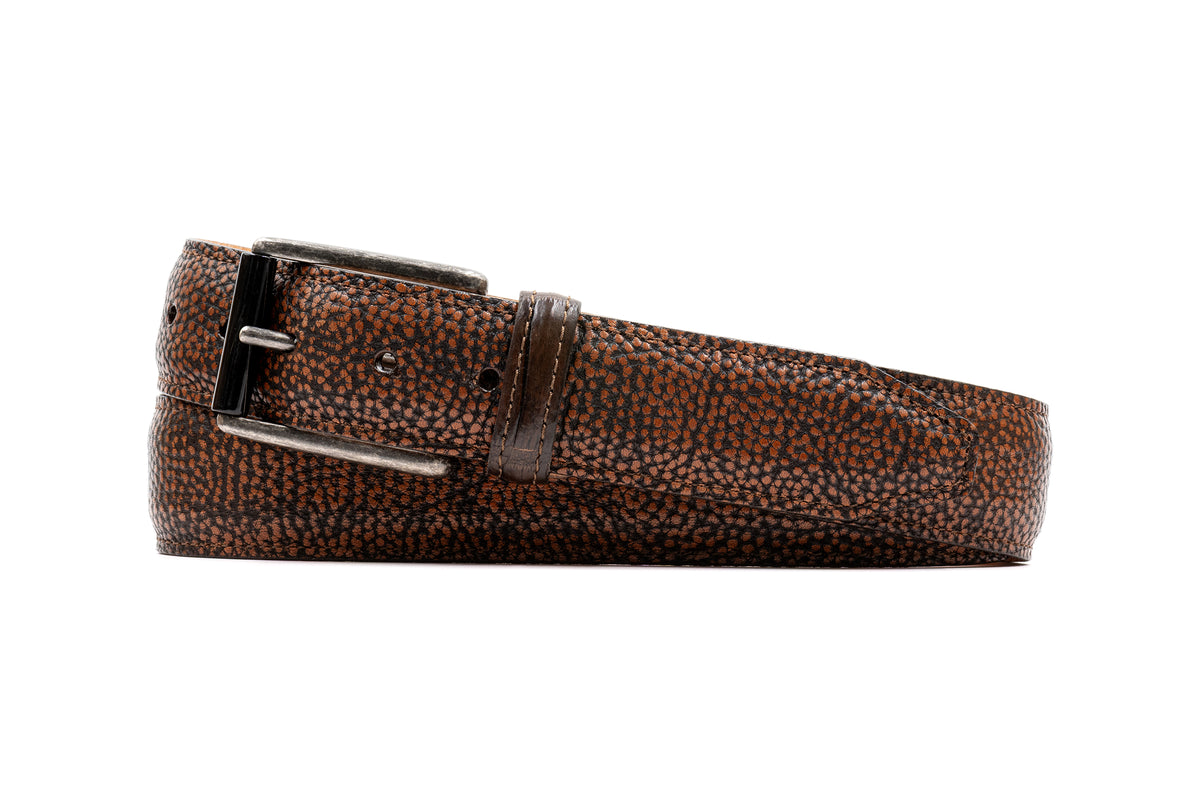 Martin Dingman Hayes Pebble Grain Saddle Leather Belt with classic styling and a silver buckle, coiled on a white background.