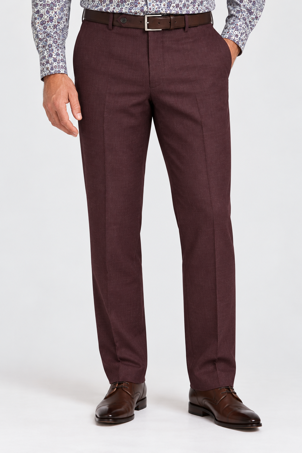 A man wearing burgundy Ballin SOHO M5919 Super 120′s Wool Seasonal Dress Pants, a patterned shirt, a brown leather belt, and brown leather dress shoes.