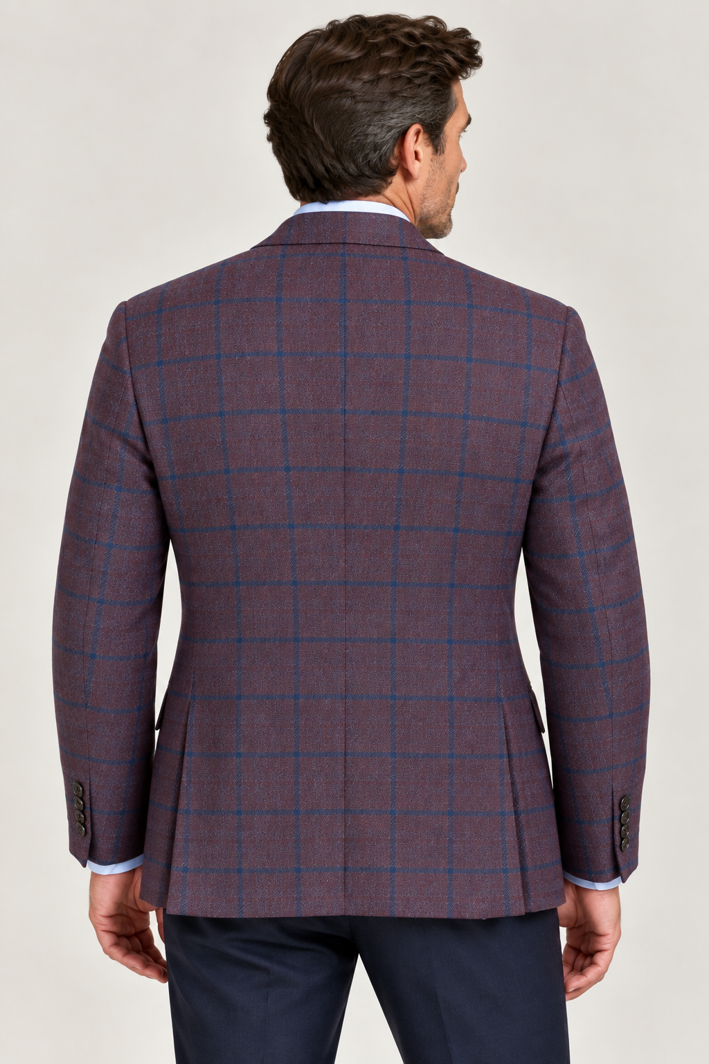 A man shown from the back against a plain light background wears the TailoRed Maroon Navy Windowpane Wool Sport Coat by TailoRed, crafted from fine Italian fabric, paired with navy trousers.