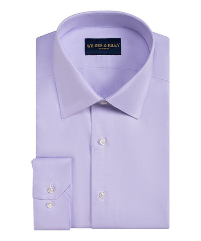 A neatly folded light purple Wilkes & Riley Queens Classic B&T Supima cotton dress shirt with a spread collar and buttoned cuffs, labeled Wilkes & Riley inside the collar.