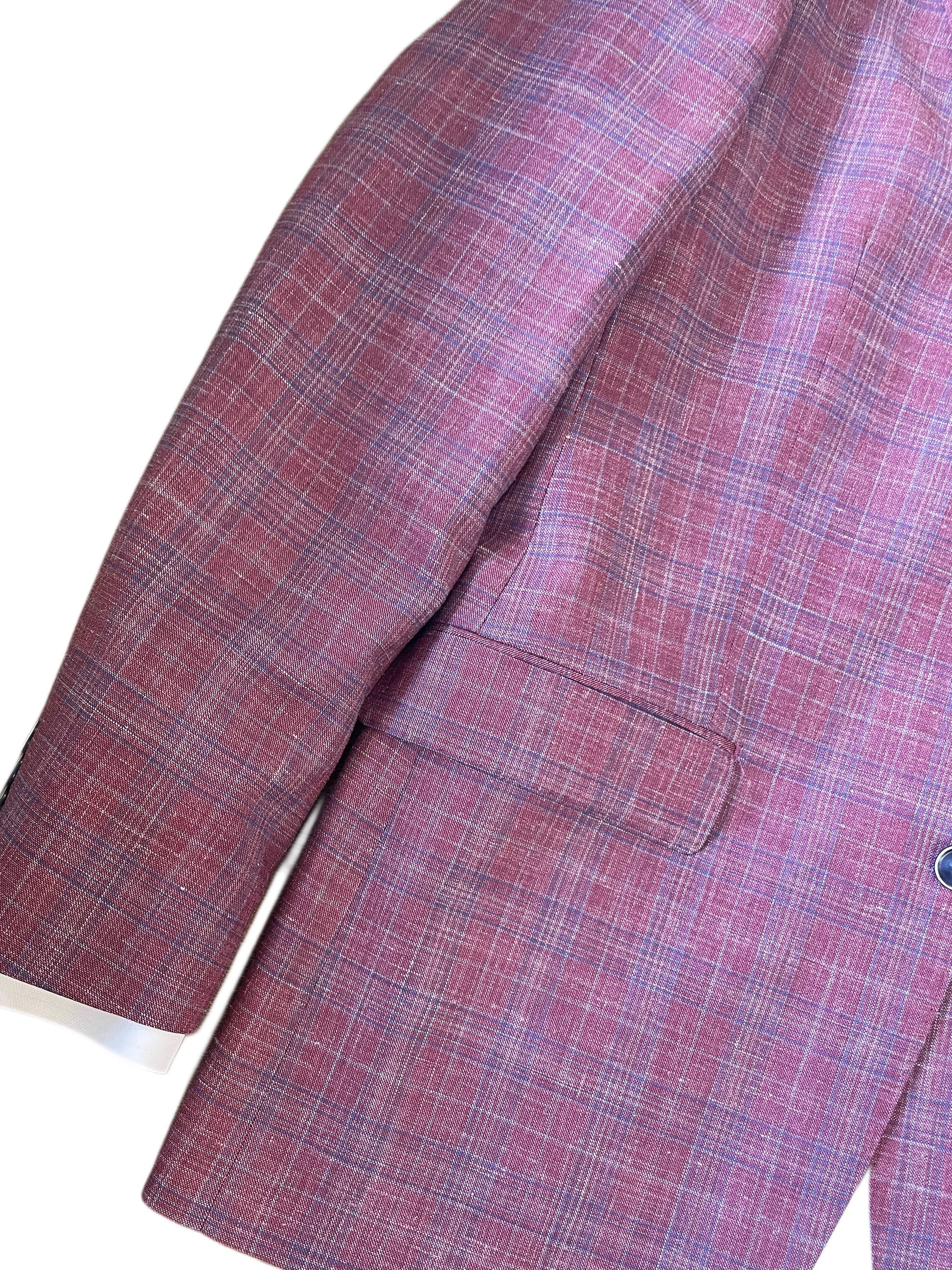 Cropped image of TailoRed Gilmore Sport Coat 8130538 sleeve and side pocket in pink berry plaid, made from fine Italian fabric, shown against a white background.