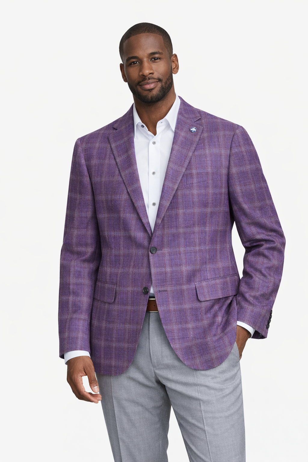 A man wearing the Byron Luca Soft Sport Coat 9547 by Byron, paired with a white dress shirt and light gray pants, stands against a plain white background.