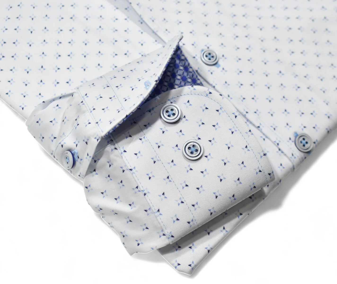 The Marcello OP Star Medallion Sport Shirt W114 by Marcello features a classic fit and long sleeves, with a subtle blue geometric pattern and blue buttons on smooth cotton sateen, neatly folded against a white background.