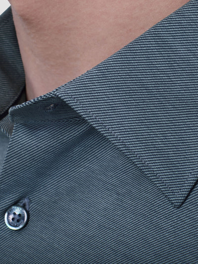 Close-up of a person wearing the Bugatchi James Long Sleeve Shirt HF9556K60, a gray, diagonally striped button-up by Bugatchi with a pointed collar, crafted from premium fabrics inspired by Italian menswear.