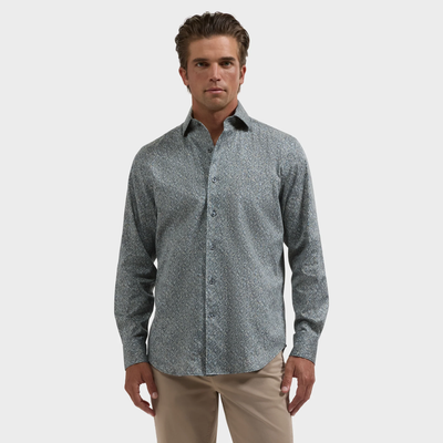 A man wearing the Bugatchi Alvin Floral Sport Shirt and beige pants stands against a plain white background.