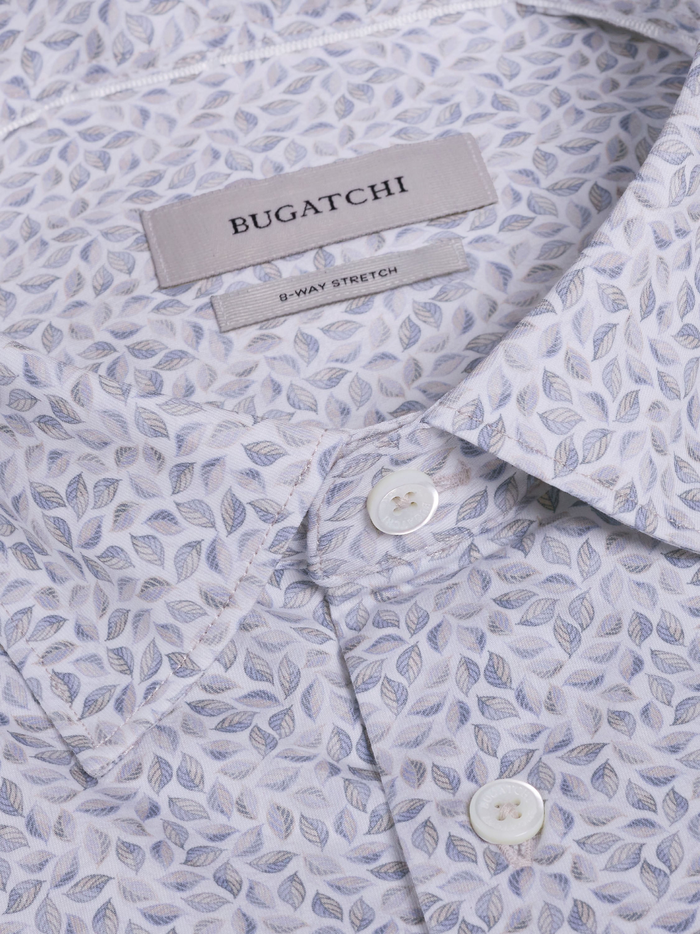 Close-up of the Bugatchi OP James OoohCotton® Leaf Print Shirt JF9212K60—a light-colored, wrinkle-resistant shirt with a small leaf pattern and white buttons; stylish and versatile for any occasion.