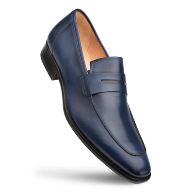 A single Mezlan Calfskin Penny Loafer E20243 in blue, featuring a low black heel and refined stitched detailing, handcrafted from premium calfskin leather by Mezlan, is displayed at an angle on a white background.