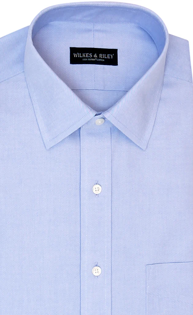 Wilkes & Riley Blue B1025 Big&Tall dress shirt, light blue Supima cotton with a collar, white buttons, visible front pocket, and Wilkes & Riley label inside the collar.