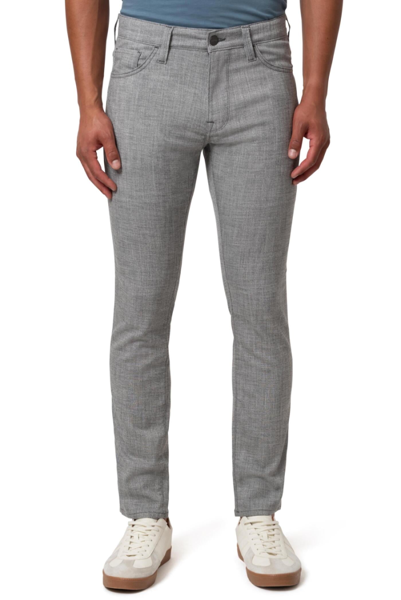 A person wearing 34 Heritage Charisma Grey Cross Twill relaxed straight-leg pants and white sneakers, standing with arms relaxed at their sides, shown from the shoulders down.