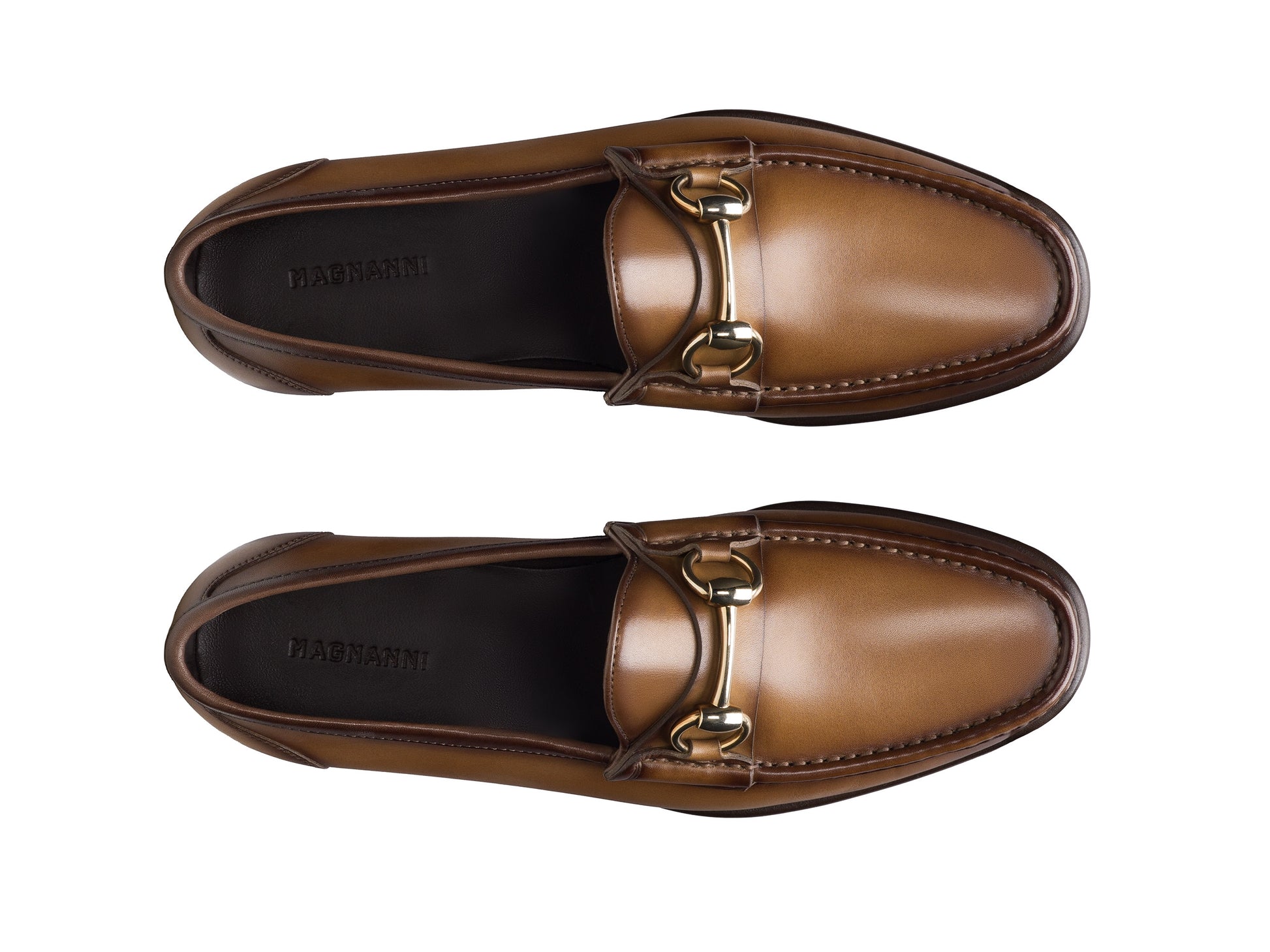 The Magnanni Giancarlo Moc Toe Bit Loafer by Magnanni, crafted from brown calfskin with gold metal bit detail and subtle hand-stitched accents, is shown from above on a white background.
