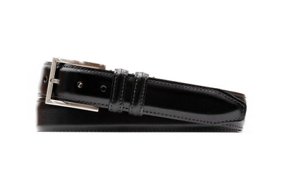 The Martin Dingman Samuel Coachman Leather Belt is coiled flatly, displaying black leather, classic stitching, a silver buckle, and two loops.
