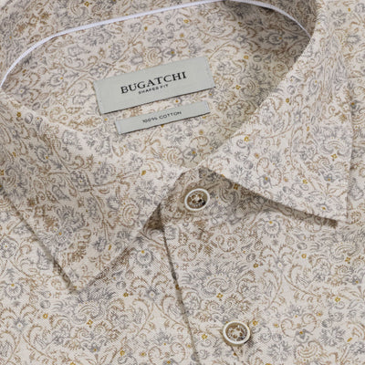 Close-up of the Bugatchi Axel Paisley Sport Shirt KS3132L40S, a long-sleeve Italian cotton shirt featuring a subtle beige, grey, and gold paisley design. The shirt includes a pointed collar and two visible buttons for an elegant, refined touch.