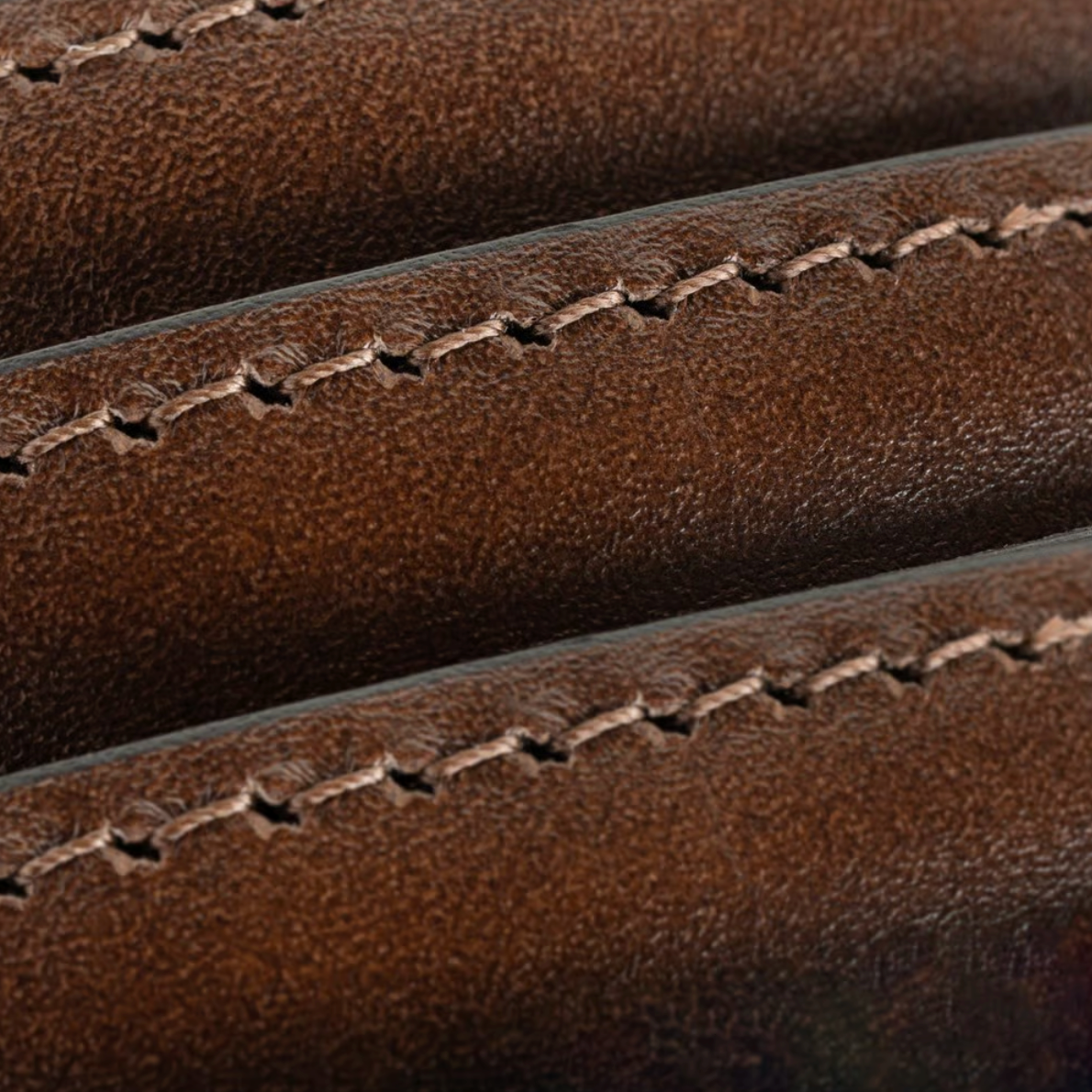 Close-up of the Allen Edmonds Wide Basic Belt Big and Tall, handcrafted in America from brown leather, featuring visible stitching that highlights the texture and parallel seams.
