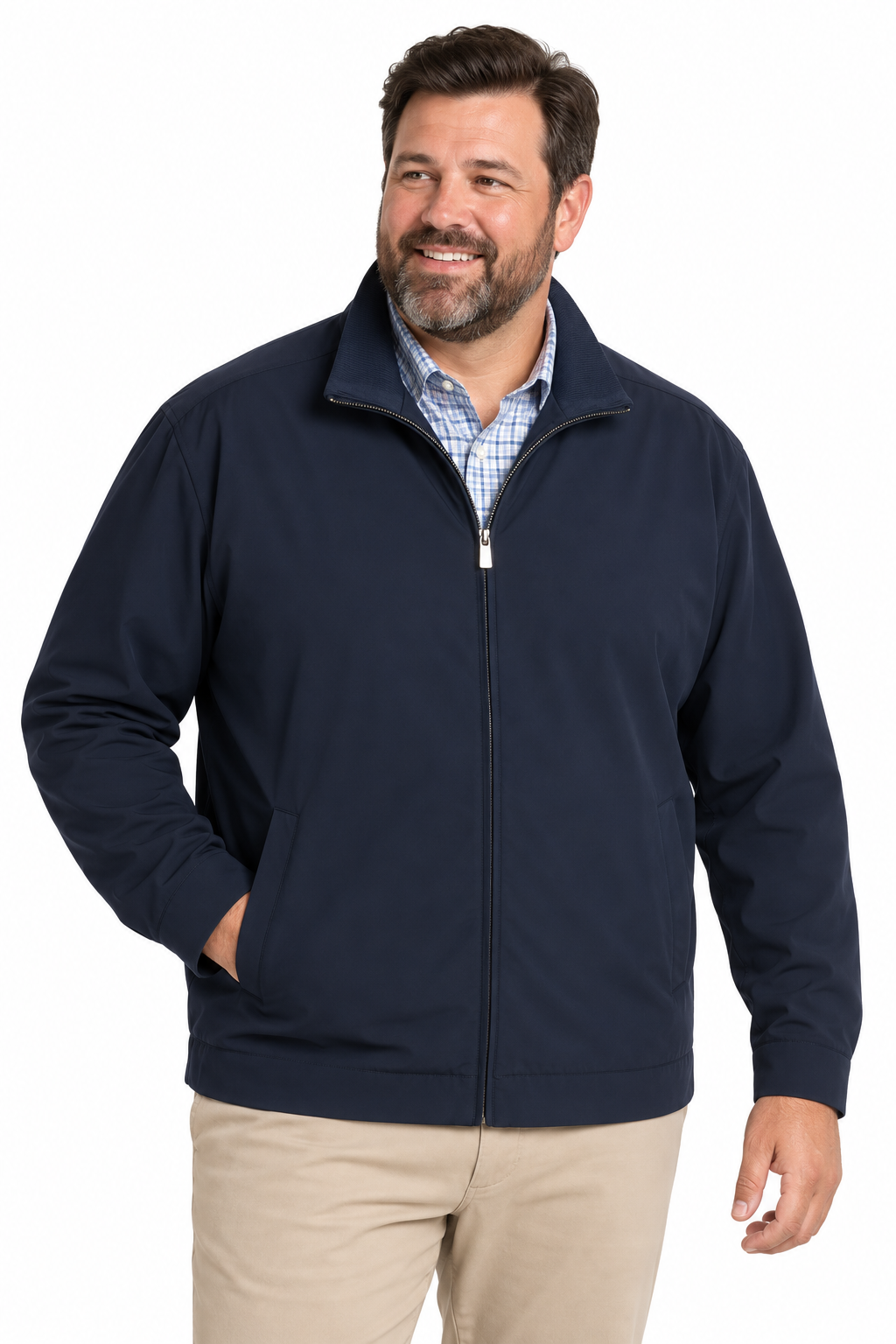 A man wears a navy blue Hart Schaffner Marx Ryan Waterproof Jacket Big & Tall over a light blue plaid shirt and khaki trousers.