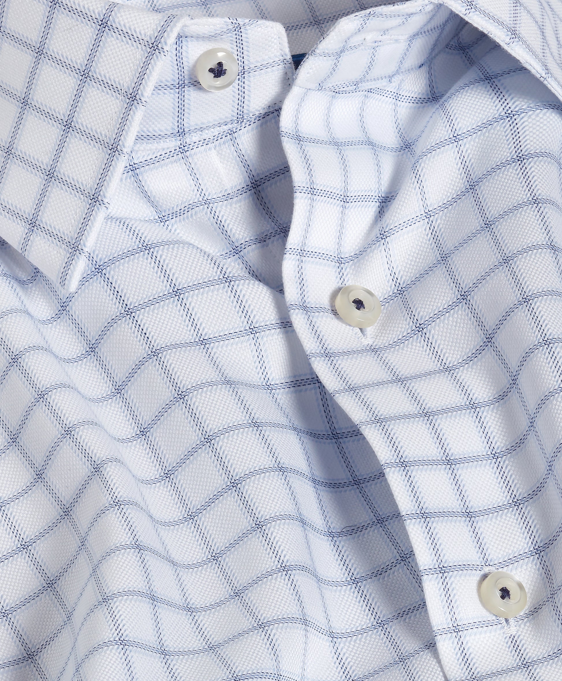 Close-up of the David Donahue Windowpane Check Dress Shirt TBSP13810, a men’s dress shirt by David Donahue, crafted from premium Pima cotton and featuring a white and navy windowpane pattern with classic white buttons.