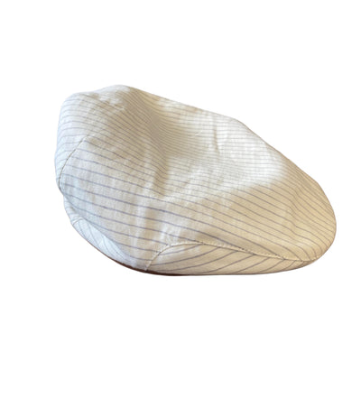 The Wigens Linen Ivy Cap 90483 by Wigens is a white flat cap with thin gray pinstripes, a short curved peak, and a narrow shaped crown, shown on a white background.