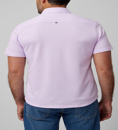 A man is seen from the back against a plain background, wearing blue jeans and a light purple Stone Rose SS Pique Shirt 2K7T241.